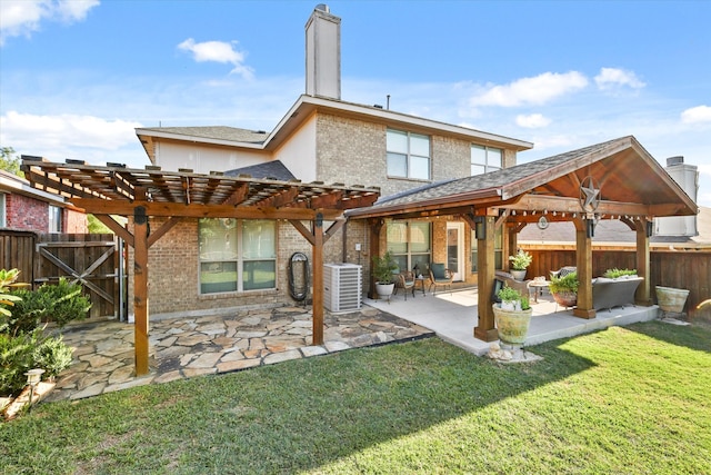 back of house with central air condition unit, outdoor lounge area, a yard, and a patio