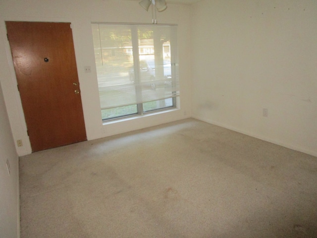 empty room with light carpet and ceiling fan