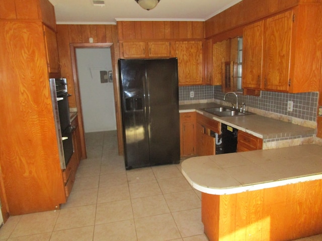 kitchen featuring kitchen peninsula, sink, black appliances, light tile patterned floors, and tasteful backsplash