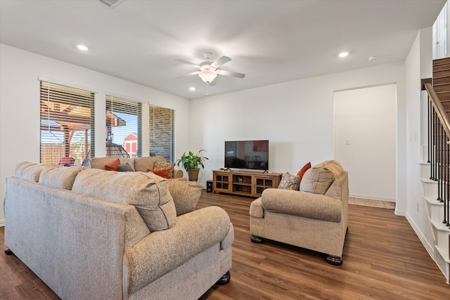 living room with ceiling fan and dark hardwood / wood-style flooring