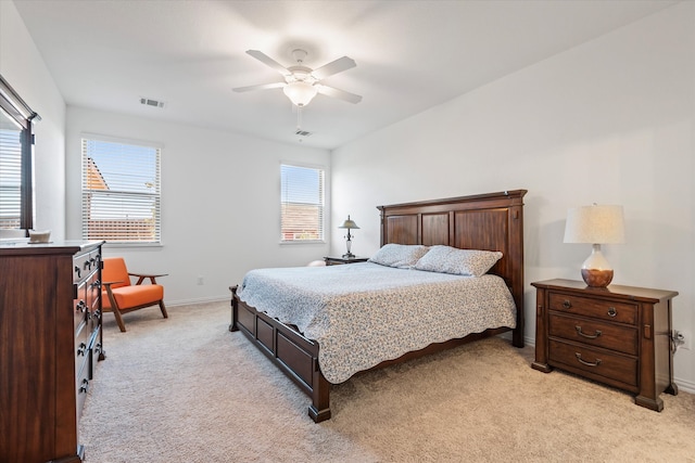 bedroom with light carpet and ceiling fan