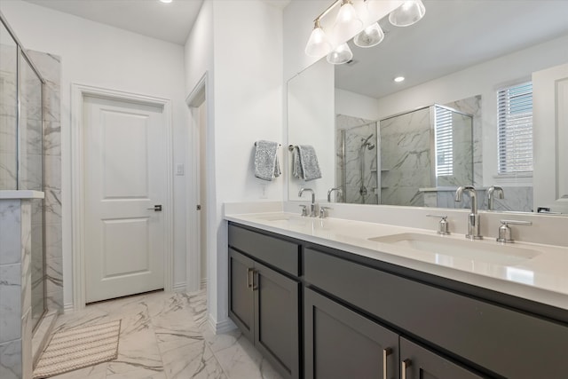 bathroom with vanity and a shower with shower door