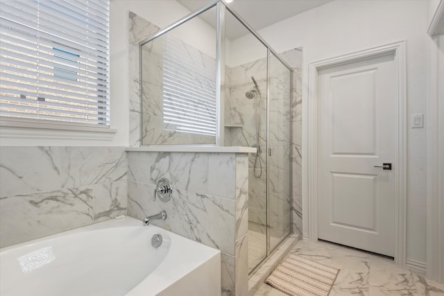 bathroom featuring independent shower and bath