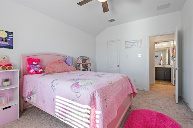 bedroom featuring connected bathroom, vaulted ceiling, light colored carpet, and ceiling fan