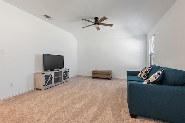 carpeted living room with ceiling fan and lofted ceiling