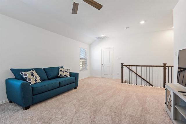 sitting room featuring light carpet, vaulted ceiling, and ceiling fan