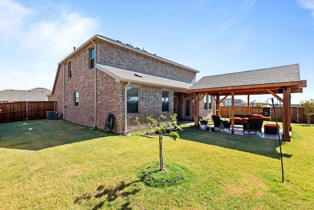 rear view of house featuring a patio area, a yard, central AC unit, and an outdoor hangout area