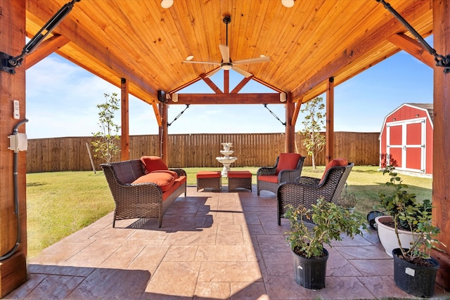 view of patio featuring a gazebo, an outdoor hangout area, a storage shed, and ceiling fan