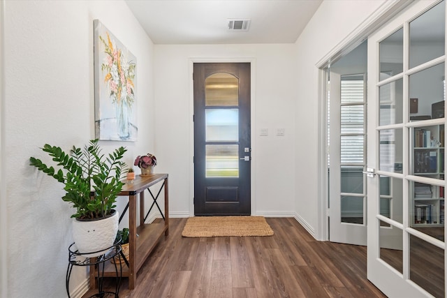 foyer with a wealth of natural light and dark hardwood / wood-style flooring