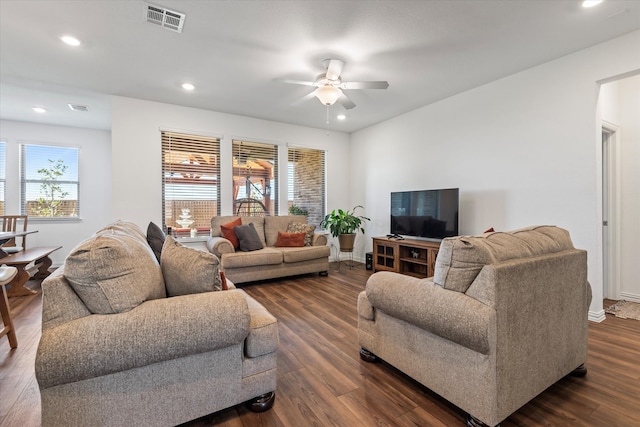 living room with a wealth of natural light, dark hardwood / wood-style floors, and ceiling fan