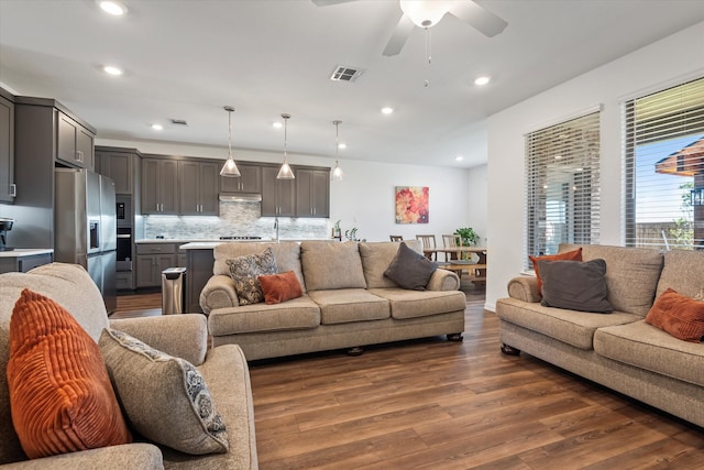 living room featuring sink, dark hardwood / wood-style floors, and ceiling fan