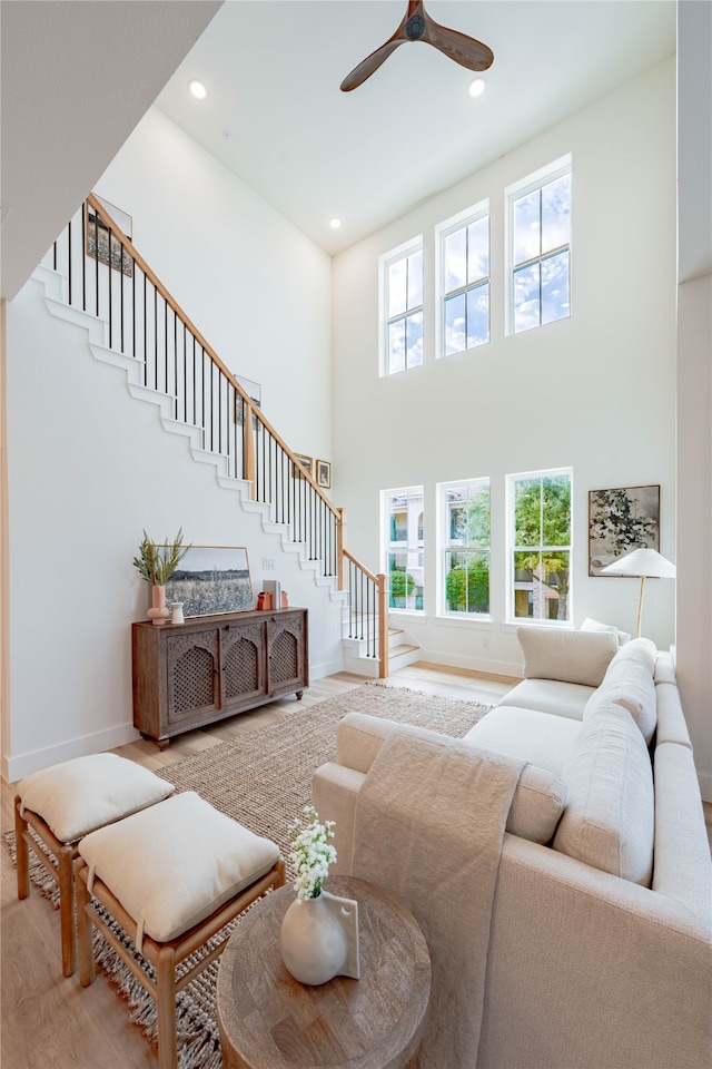 living room featuring a high ceiling, hardwood / wood-style flooring, and plenty of natural light