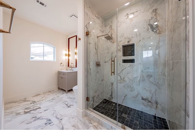 bathroom featuring vanity, toilet, and a shower with door