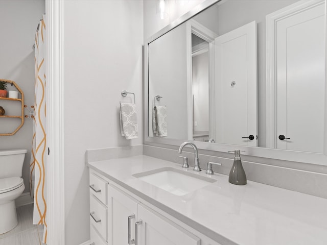 bathroom featuring vanity, toilet, and tile patterned floors