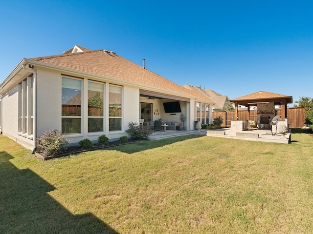 rear view of house with a gazebo, a patio area, a lawn, and an outdoor living space