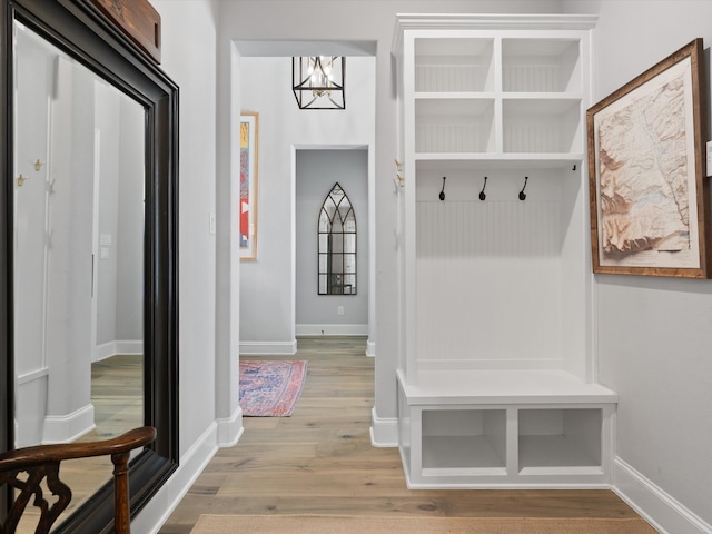 mudroom with light hardwood / wood-style flooring and an inviting chandelier