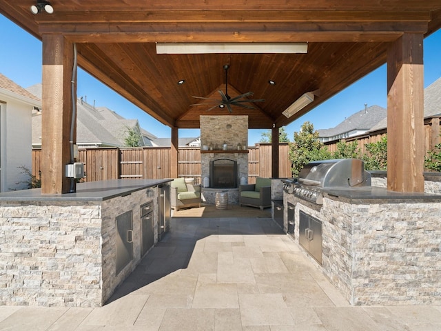 241 Bunton Branch Ln, Prosper, TX 75078 - fenced backyard with an outdoor stone fireplace, a gazebo, a patio area, and ceiling fan