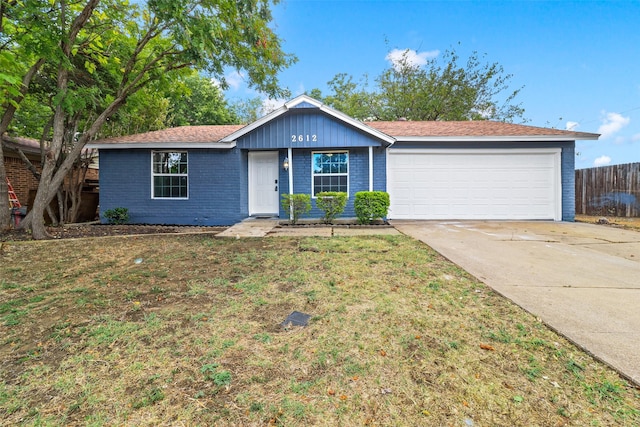 single story home featuring a front yard and a garage