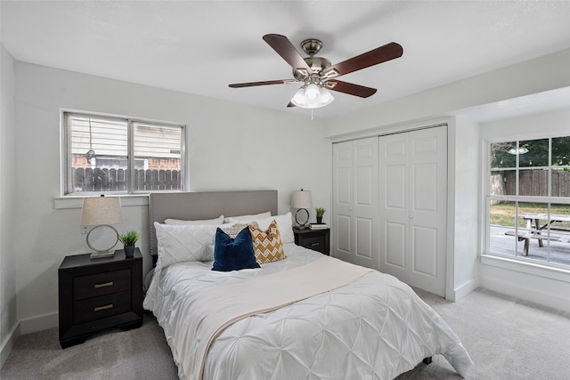 bedroom with light carpet, a closet, and ceiling fan