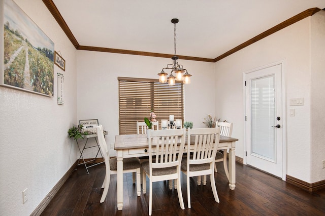 dining area featuring dark hardwood / wood-style flooring, crown molding, and a notable chandelier