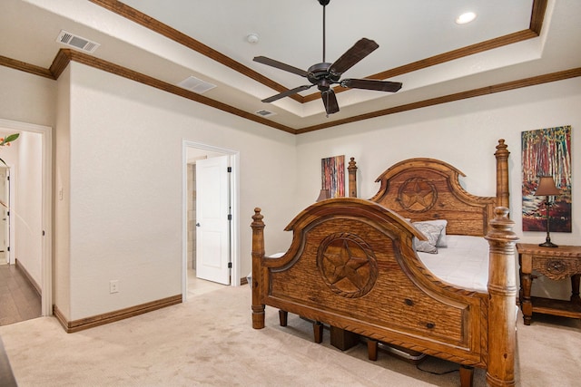 carpeted bedroom with ceiling fan, ornamental molding, and a tray ceiling