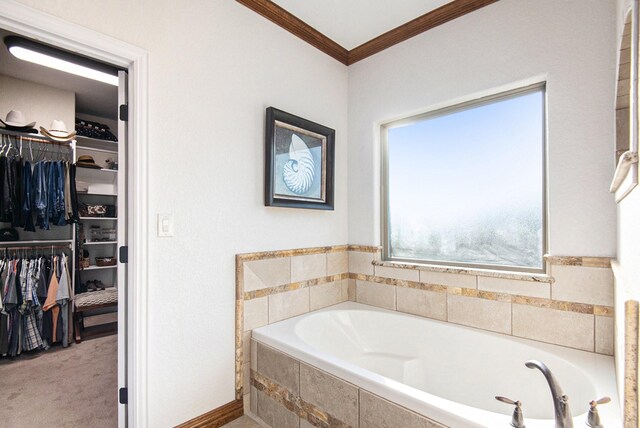 bathroom with tile patterned floors, vanity, ornamental molding, and a washtub