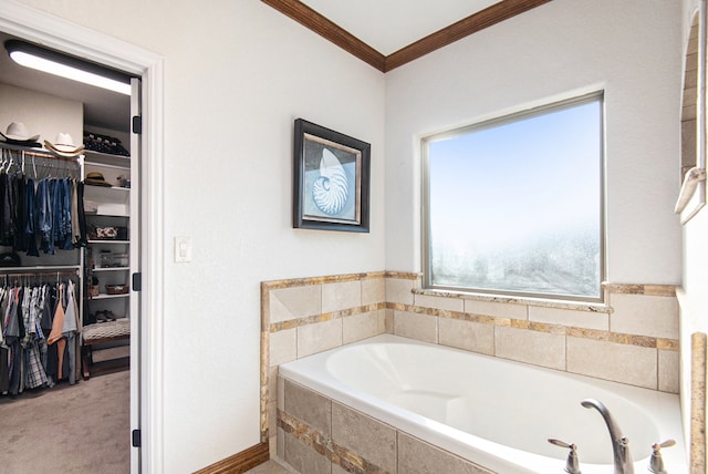 bathroom with a relaxing tiled tub and crown molding