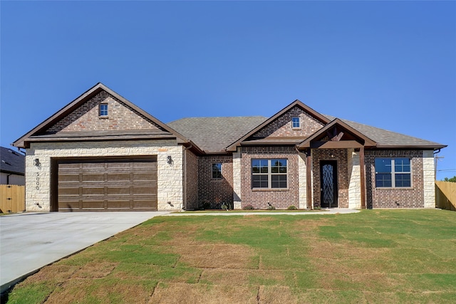 view of front of property featuring a garage and a front lawn