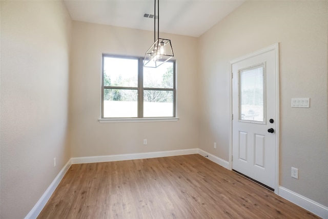 unfurnished dining area featuring light hardwood / wood-style flooring