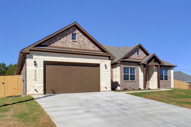 view of front facade featuring a garage and a front lawn