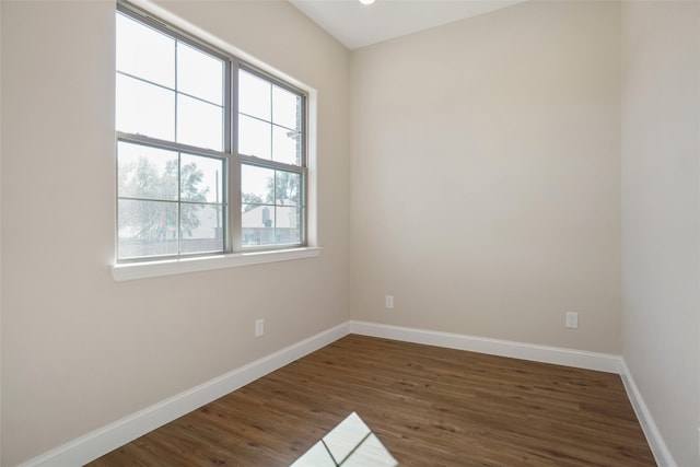 spare room with dark hardwood / wood-style flooring