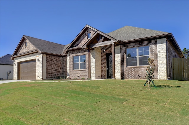 craftsman inspired home with a garage and a front lawn