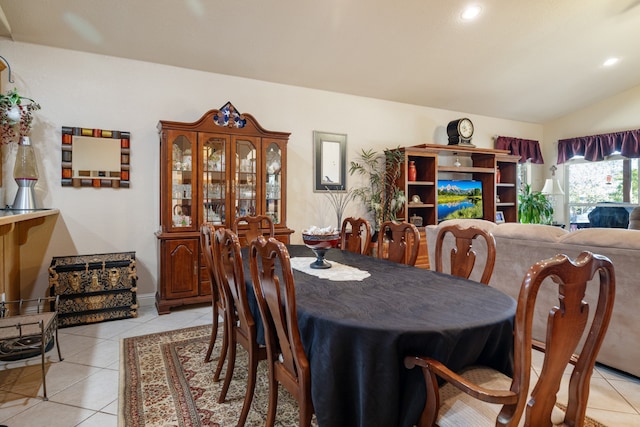 tiled dining space with lofted ceiling