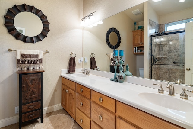 bathroom with tile patterned flooring, walk in shower, vanity, and toilet