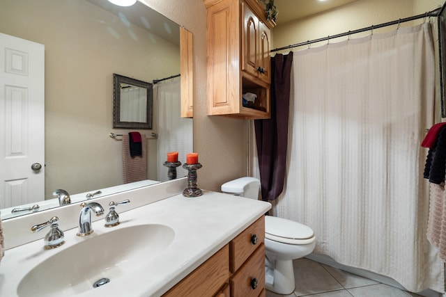 bathroom with vanity, tile patterned floors, and toilet