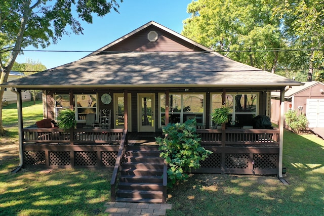 rear view of house with a wooden deck and a yard