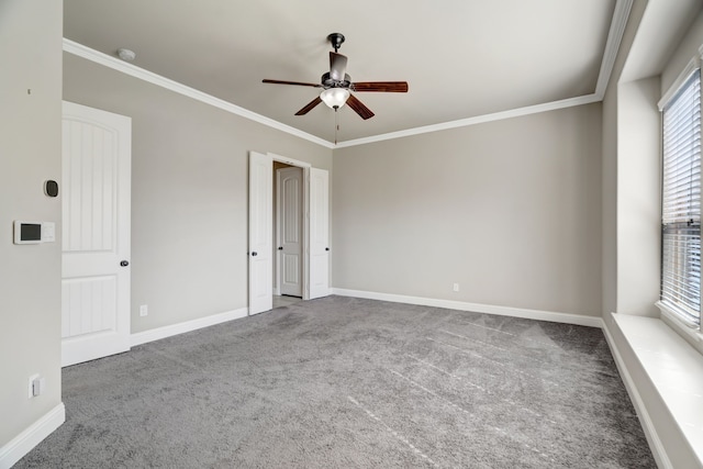 spare room featuring crown molding, carpet flooring, and plenty of natural light