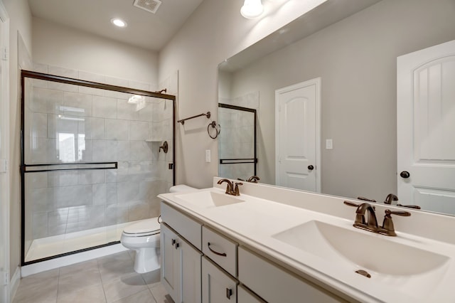 bathroom featuring vanity, a shower with shower door, toilet, and tile patterned flooring