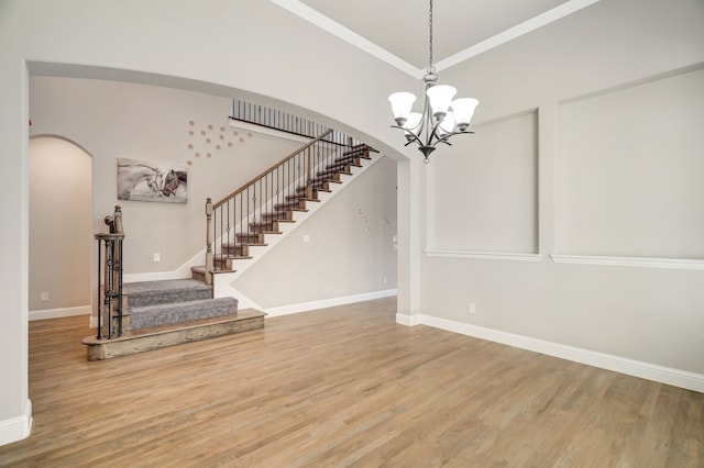 interior space with wood-type flooring and an inviting chandelier