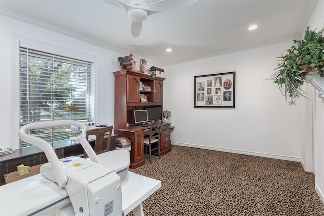 office area featuring dark colored carpet, crown molding, and ceiling fan