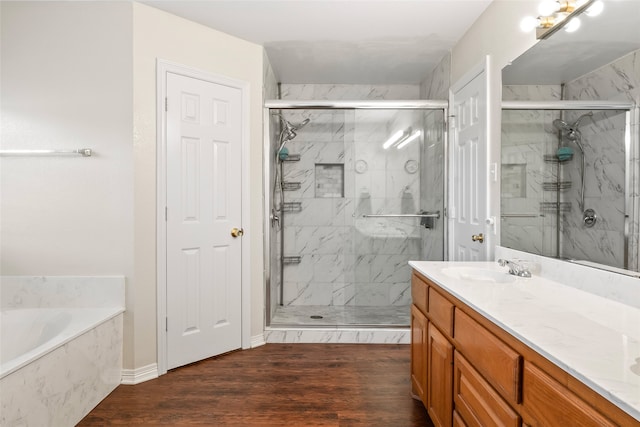 bathroom featuring vanity, plus walk in shower, and hardwood / wood-style flooring