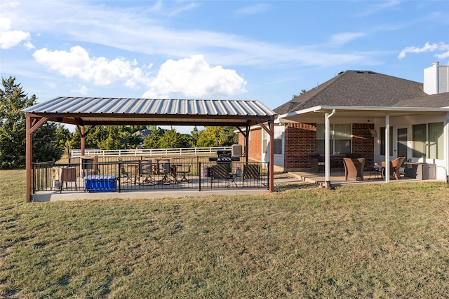 view of home's community with a yard, a patio area, and a gazebo