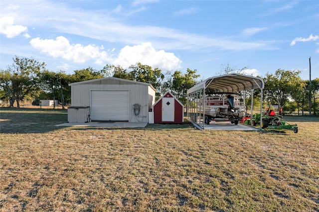 view of yard featuring an outbuilding, a garage, and a carport