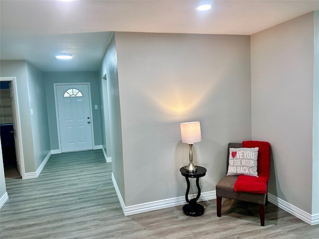 unfurnished living room featuring a brick fireplace, light wood-type flooring, and ceiling fan