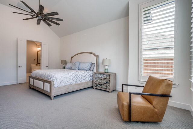 carpeted bedroom featuring ceiling fan, ensuite bathroom, and vaulted ceiling