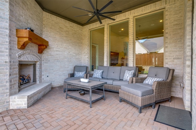 view of patio featuring an outdoor living space with a fireplace and ceiling fan