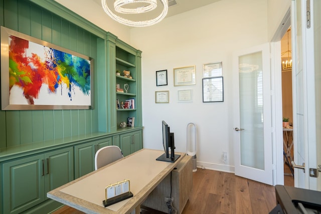 office with dark hardwood / wood-style flooring and french doors