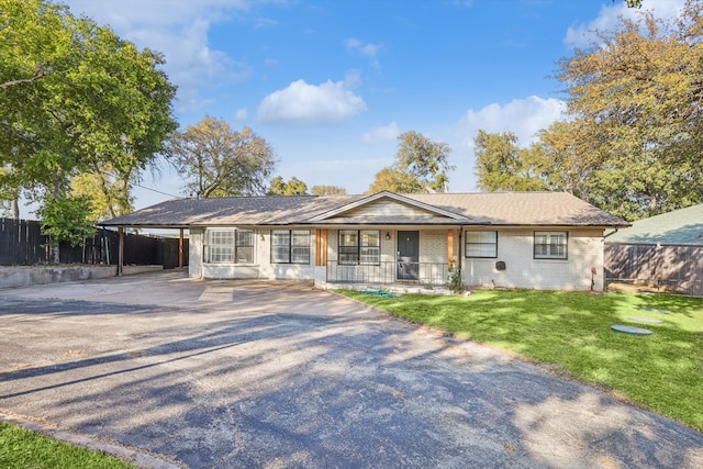 ranch-style house with a carport and a front lawn