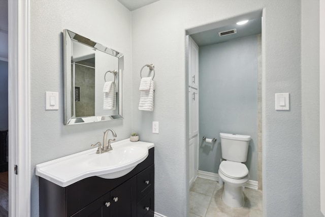 bathroom with vanity, toilet, and tile patterned floors