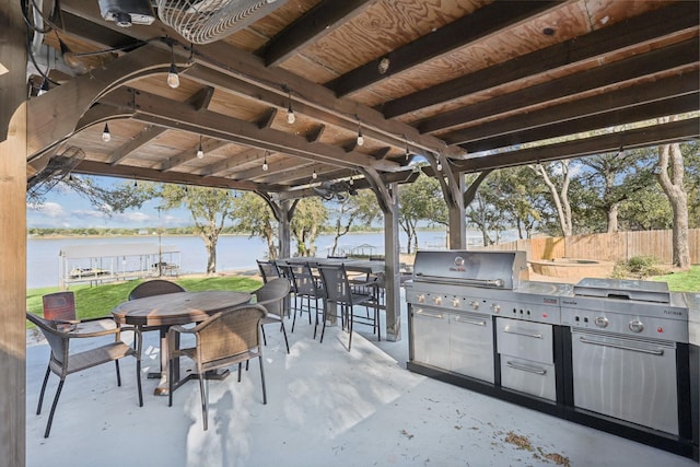 view of patio featuring a water view and area for grilling